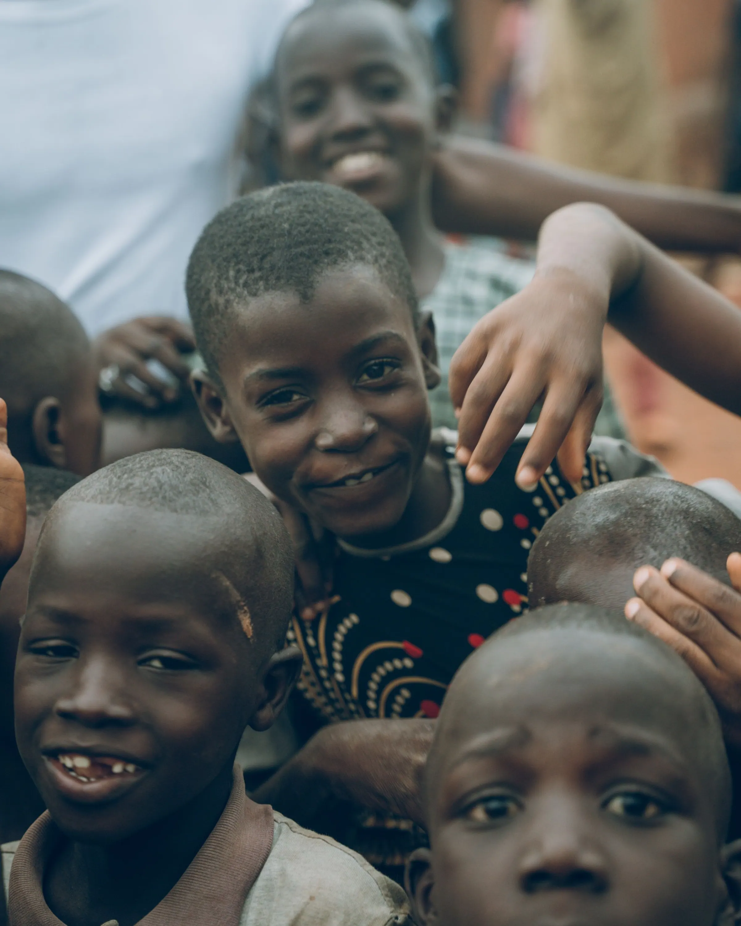 Smiling children gathered close together